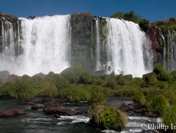 View of Iguacu Falls from observation deck over river