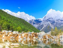 Landscape of white river and Jade Dragon Snow Mountain